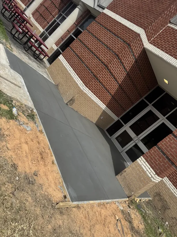 Finished ramp and landing poured against a brick building