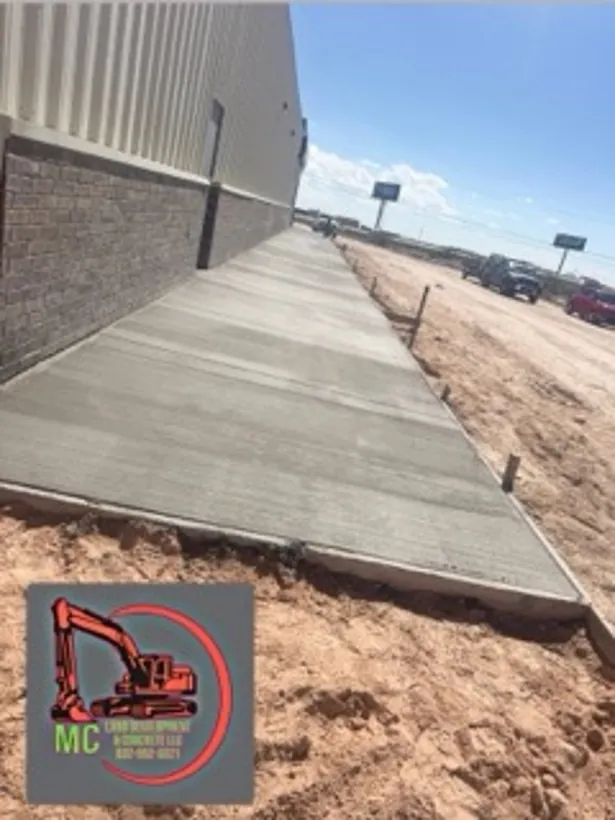 Finished walkway poured along the side of a metal building