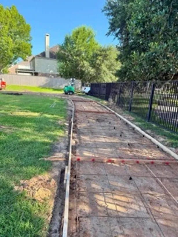 Formed walkway running alongside a fenced building