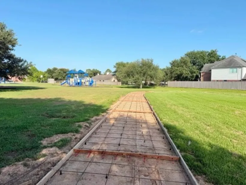 Long school walkway formed and reinforced through the field