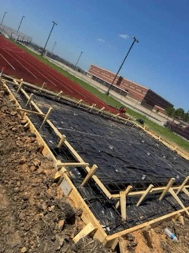 Formed and sheeted pad beside a school track