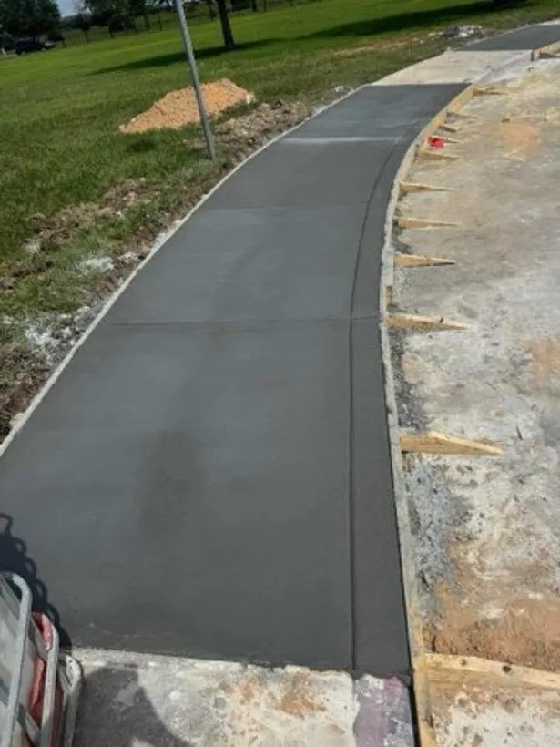 Curved finished walkway cut through a grass area