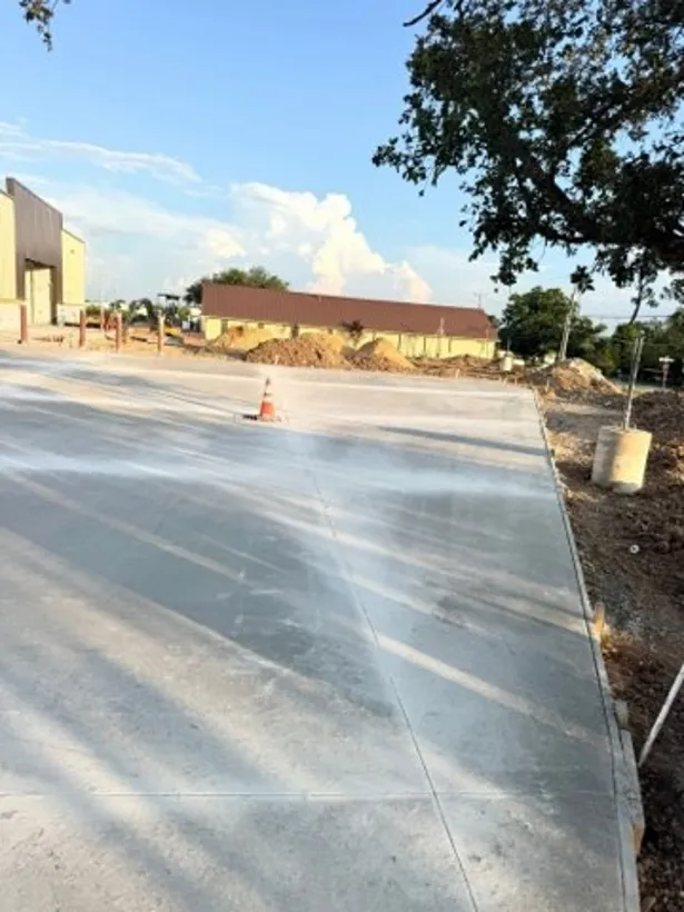Finished concrete drive running out to the roadway