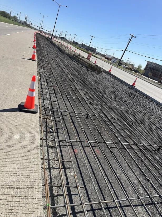 Rebar mat tied out across a full commercial parking lot
