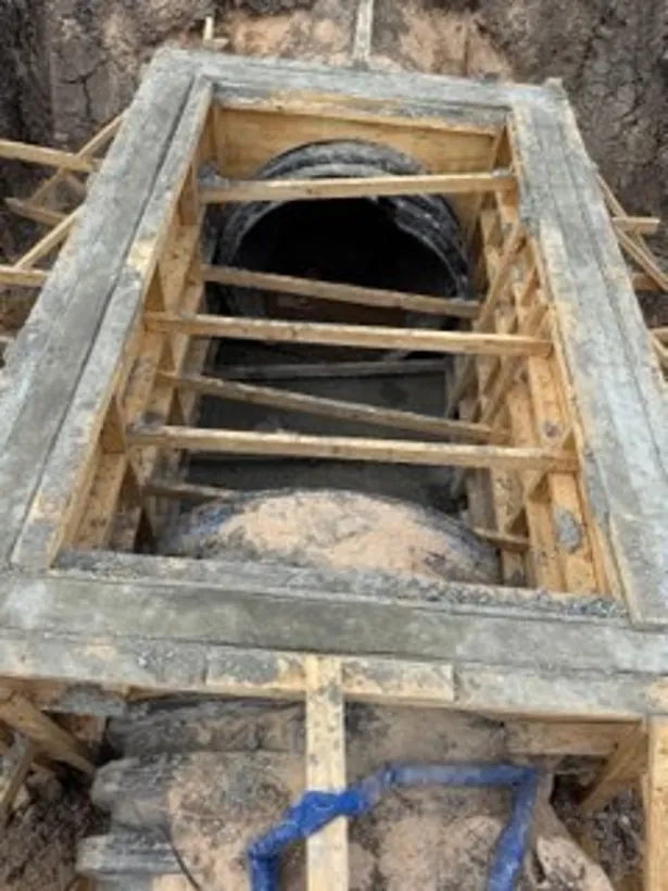 Underground box shored and formed with the pipe run through it