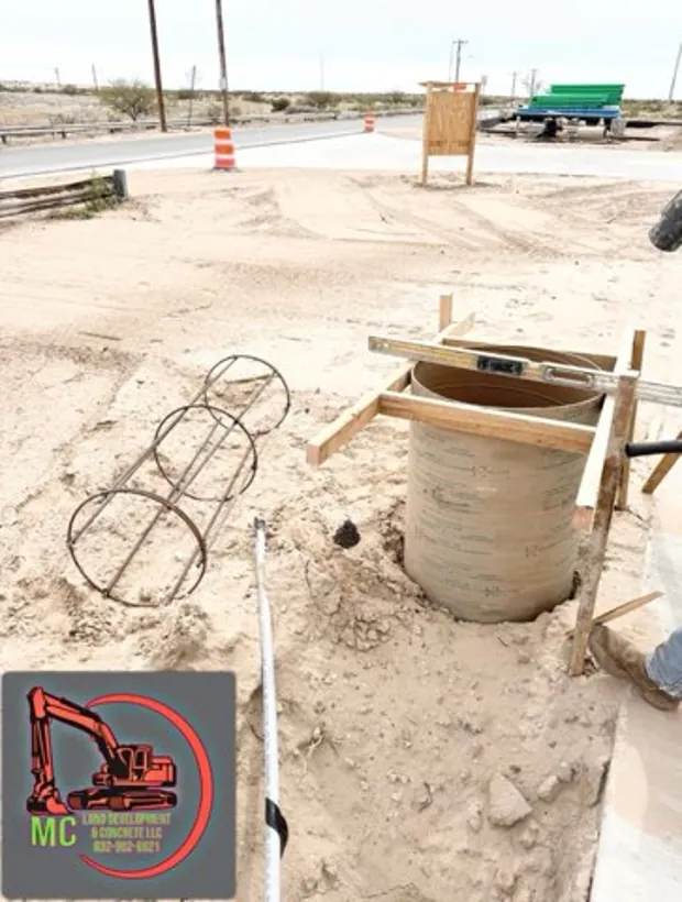 Manhole riser and rebar cage set before the surrounding pour