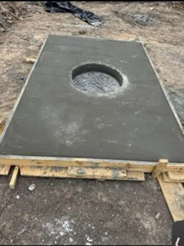 Poured concrete vault lid with the manhole opening set