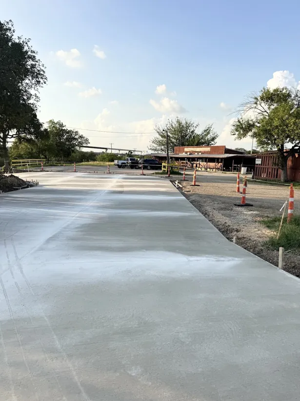 Finished concrete lot poured beside a commercial building