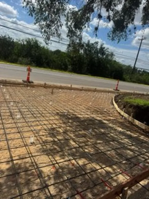 Reinforcing steel set out across a curbed commercial pad