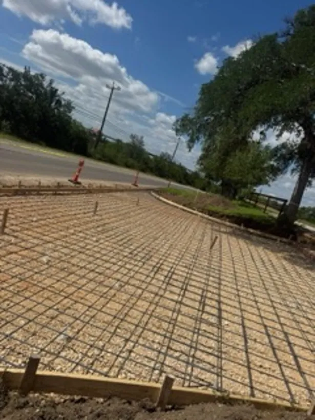 Rebar mat tied out over a formed and graded pad