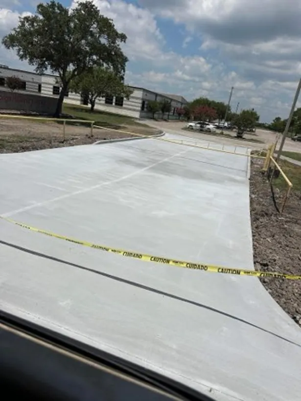 Wide finished commercial slab taped off to cure