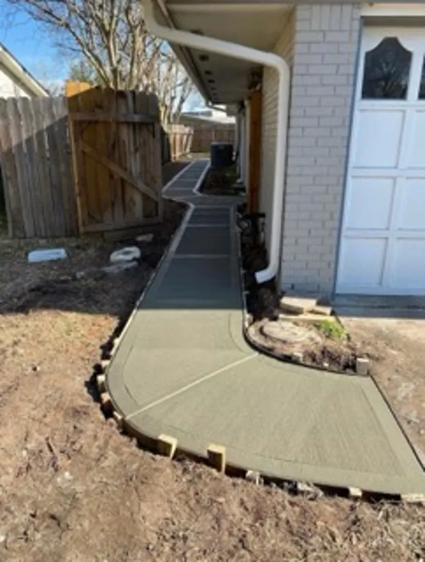 Curved finished walkway running from a house out to the street