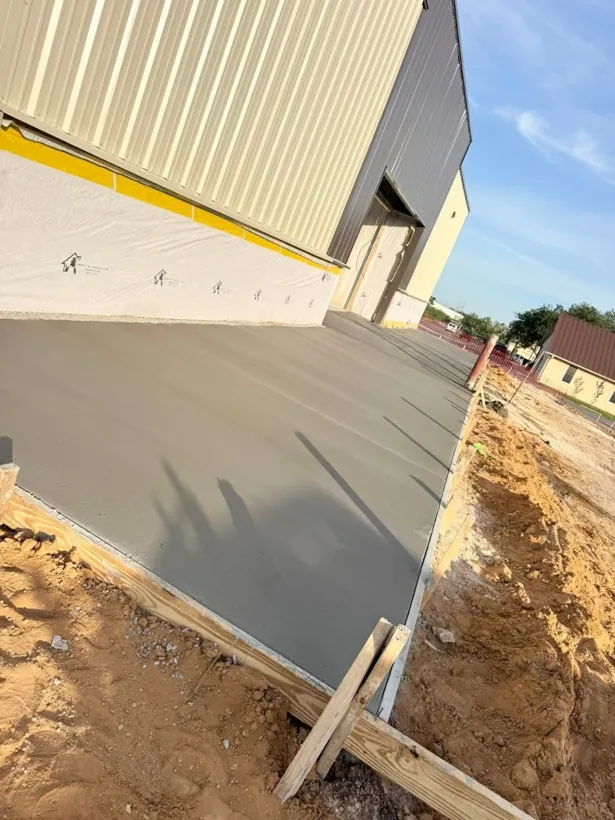 Large commercial slab poured alongside a new metal building