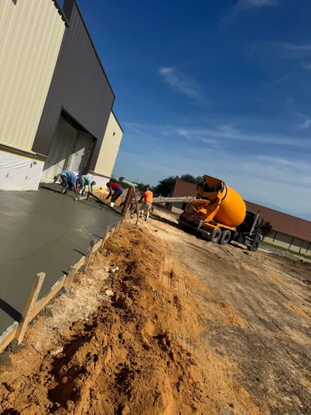 Mixer truck placing concrete on a commercial slab
