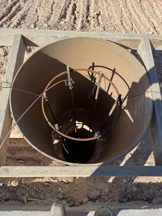 Rebar cage set inside a poured in place concrete manhole