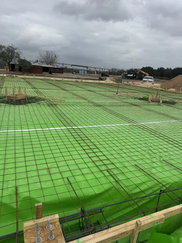 Commercial building pad with vapor barrier and full rebar mat