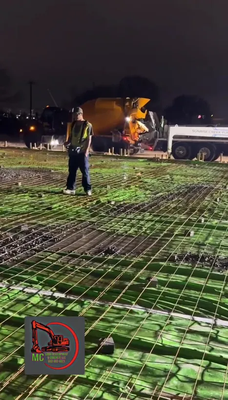 Night pour, mixer truck placing on a vapor barrier and rebar pad