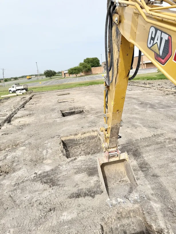 Excavator digging footings on a commercial site