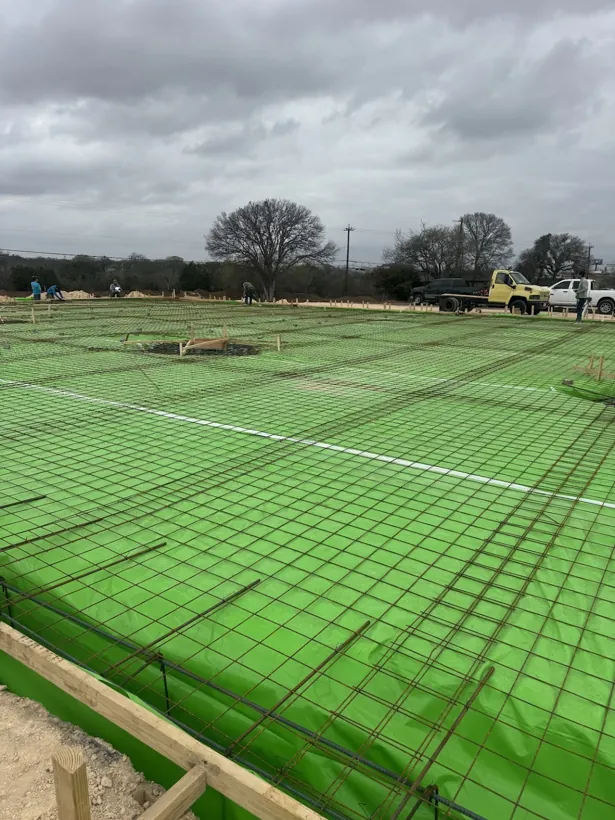 Commercial building pad with green vapor barrier and rebar mat