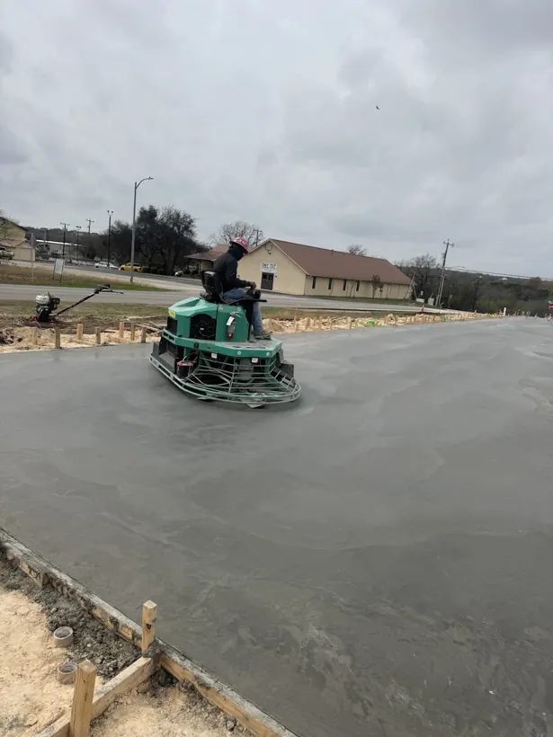 Ride-on power trowel finishing a fresh commercial slab