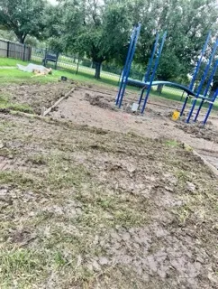 Ground graded and formed around new playground equipment