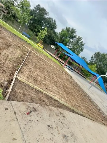 Walkway graded and formed next to a playground shade structure
