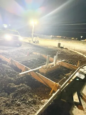 Night work, forms and rebar set with pipe sleeves under light towers